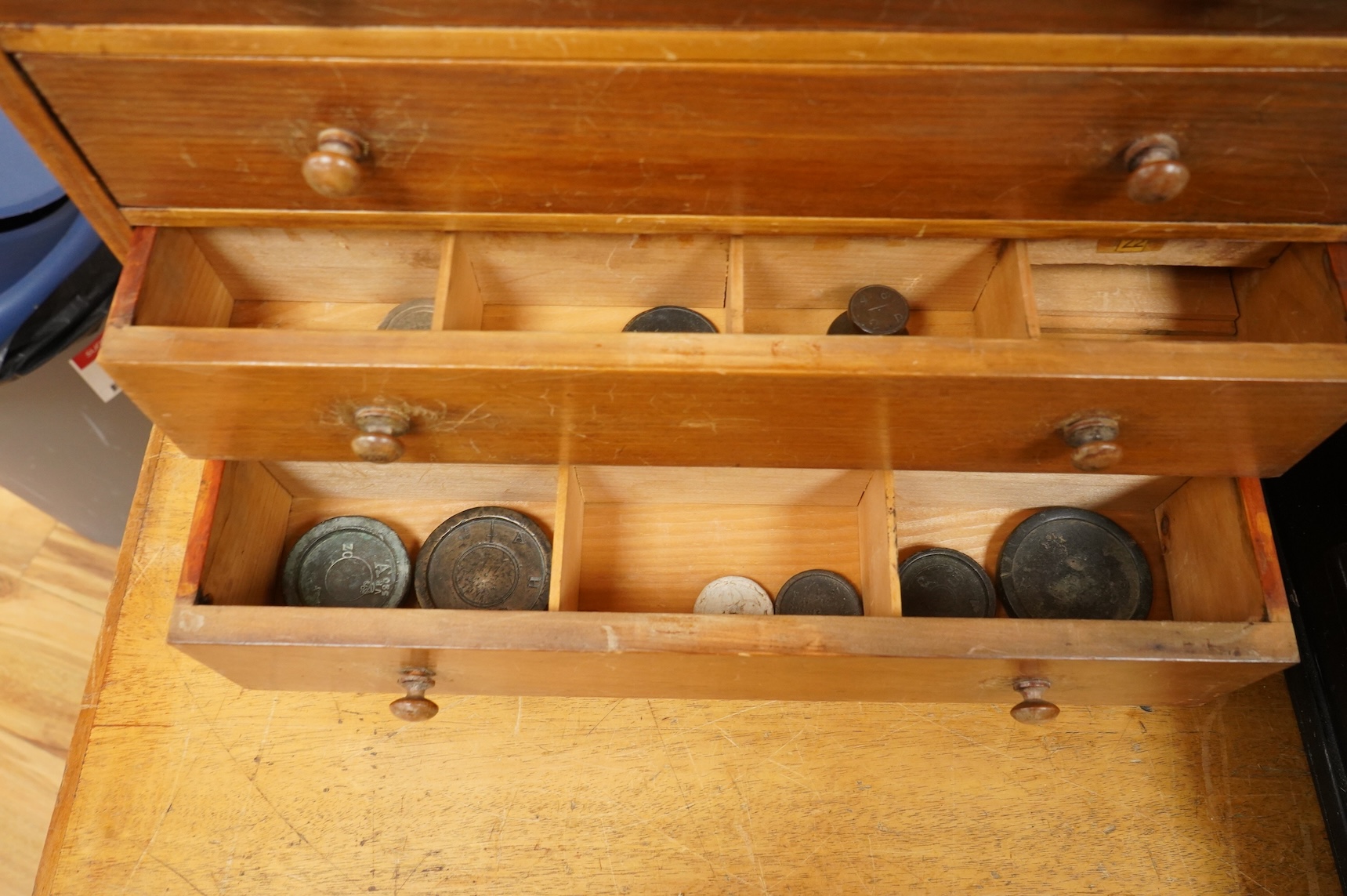 A collection of mainly 16th century to 19th century bronze and lead imperial circular trade weights stamped with Royal Cyphers, weights, the dagger assay mark for London, the ewer mark, other proof marks, etc., together